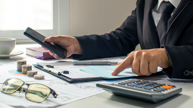 Man is calculating manual business checks totals